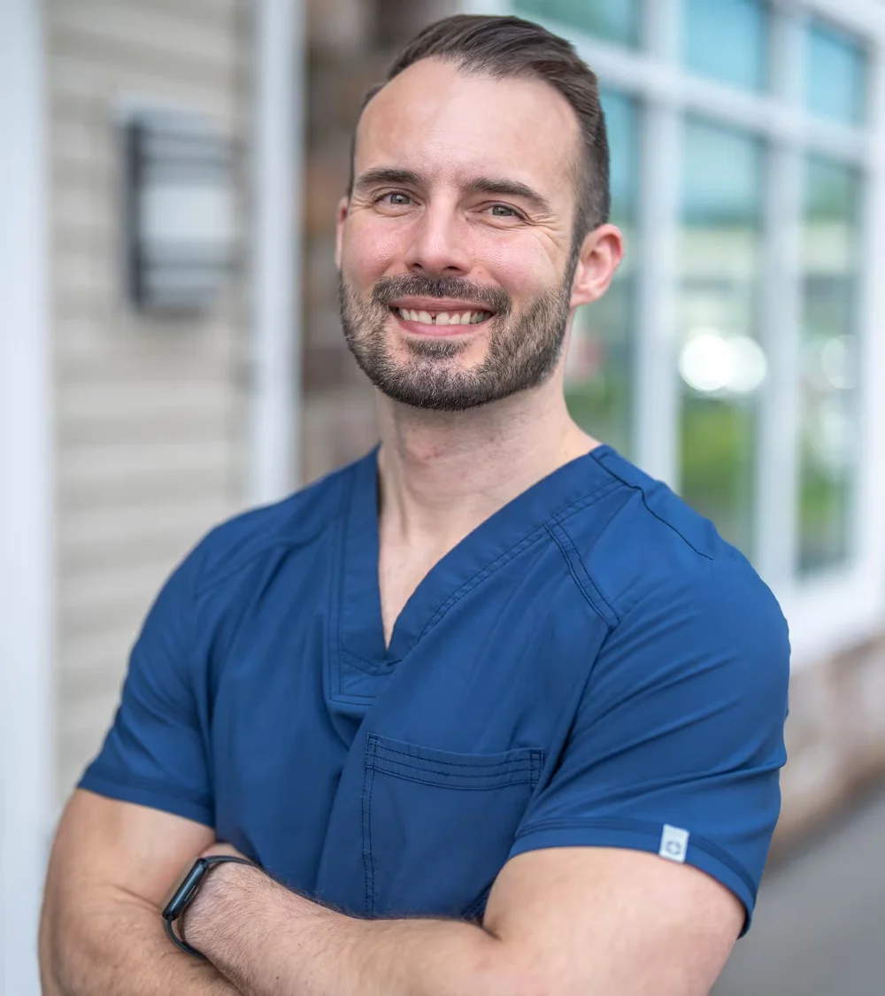 Jonathan Adler, DDS, smiling outside Spruce Grove Dental