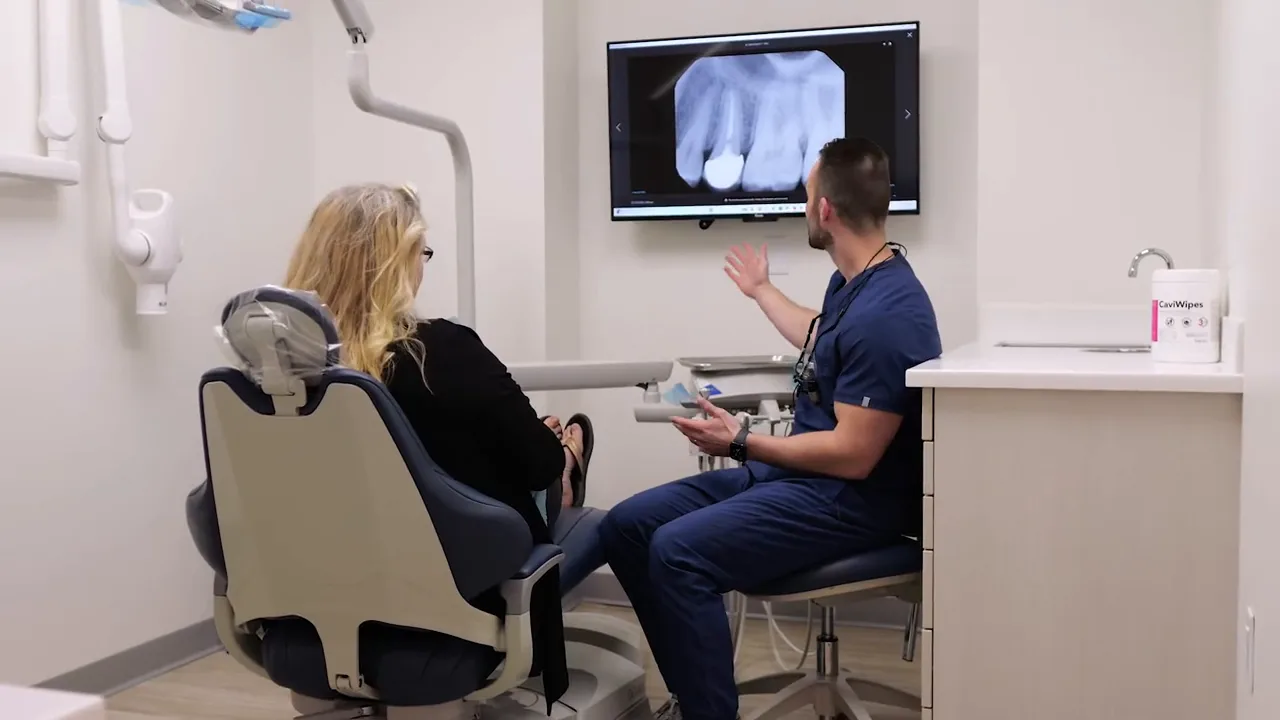 Dr. Jonathan Adler reviewing dental imaging with a patient